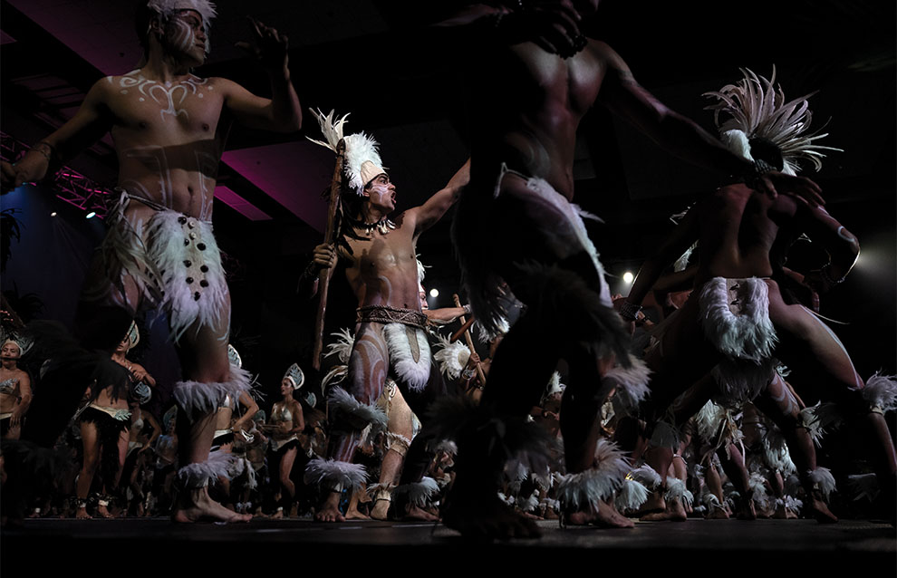 a group of people in traditional clothing, in formation for a dance