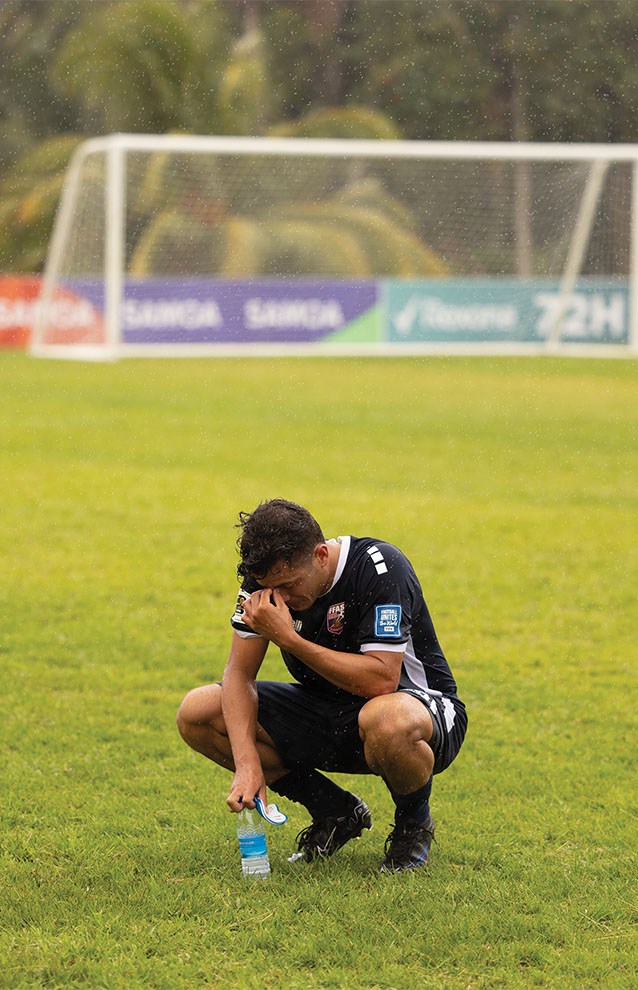 a person crouched on a field
